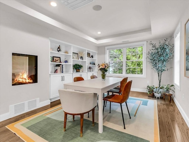 72-74 Grafton St Unit 2, Arlington, MA 02474 - dining room featuring wood finished floors, baseboards, a raised ceiling, and recessed lighting