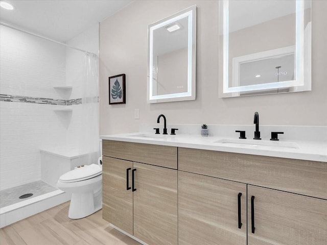 72-74 Grafton St Unit 2, Arlington, MA 02474 - bathroom featuring toilet, double vanity, and tiled shower