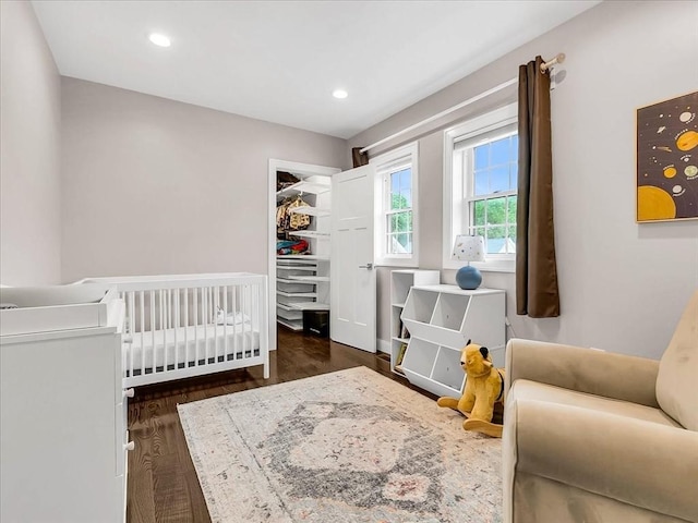 72-74 Grafton St Unit 2, Arlington, MA 02474 - bedroom featuring wood finished floors, recessed lighting, and a crib