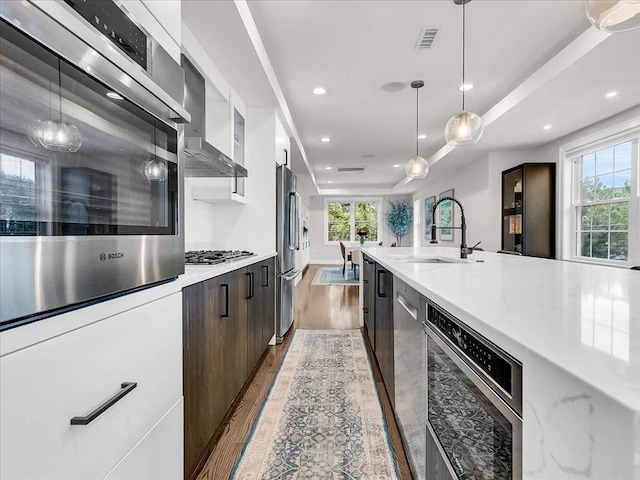 72-74 Grafton St Unit 2, Arlington, MA 02474 - kitchen featuring modern cabinets, light wood-style flooring, appliances with stainless steel finishes, healthy amount of natural light, and recessed lighting