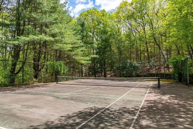 200 Pond Rd, Wellesley, MA 02482 - view of tennis court with fence and a forest view