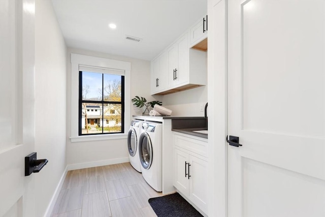 7 Fulton Rd, Lexington, MA 02420 - clothes washing area with visible vents, baseboards, cabinet space, and washer and dryer