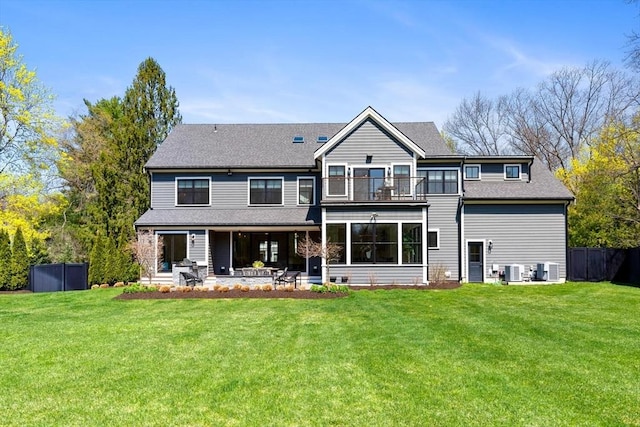 7 Fulton Rd, Lexington, MA 02420 - back of property with a lawn, central AC unit, a patio area, a balcony, and a shingled roof