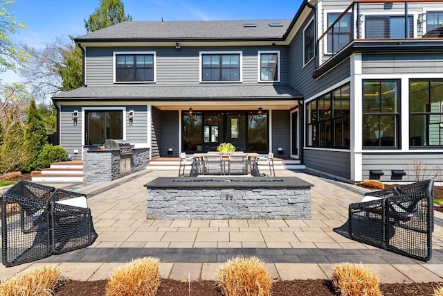 7 Fulton Rd, Lexington, MA 02420 - rear view of property with an outdoor kitchen, a fire pit, and a patio area