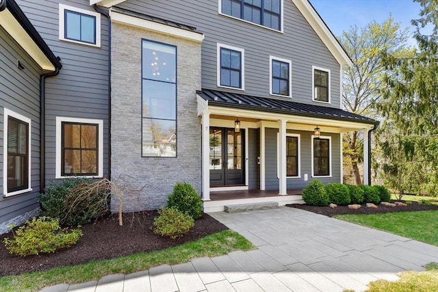 7 Fulton Rd, Lexington, MA 02420 - doorway to property featuring a standing seam roof, a porch, and metal roof