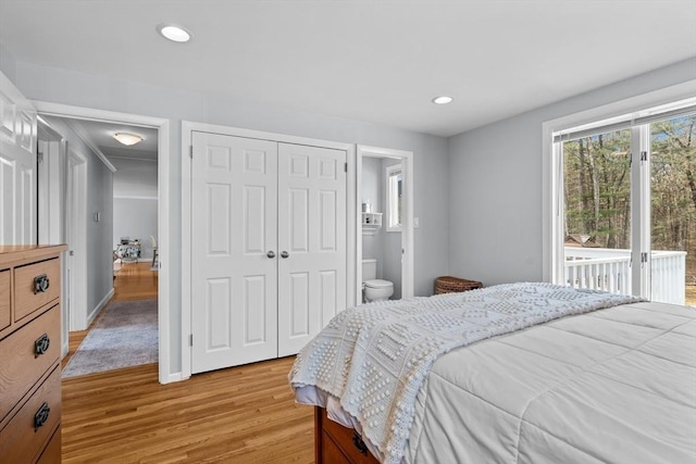 bedroom featuring ensuite bath, recessed lighting, a closet, light wood finished floors, and access to exterior