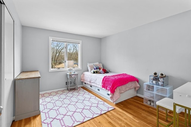 bedroom with baseboards and wood finished floors