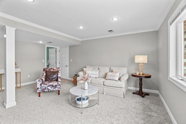 carpeted living area featuring visible vents, baseboards, ornamental molding, and decorative columns