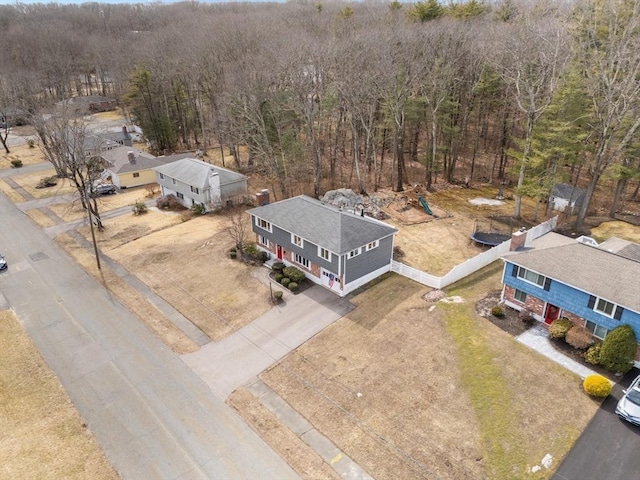 bird's eye view with a wooded view