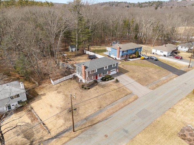 birds eye view of property featuring a view of trees