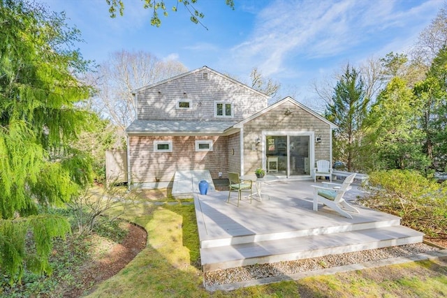 rear view of house featuring a deck