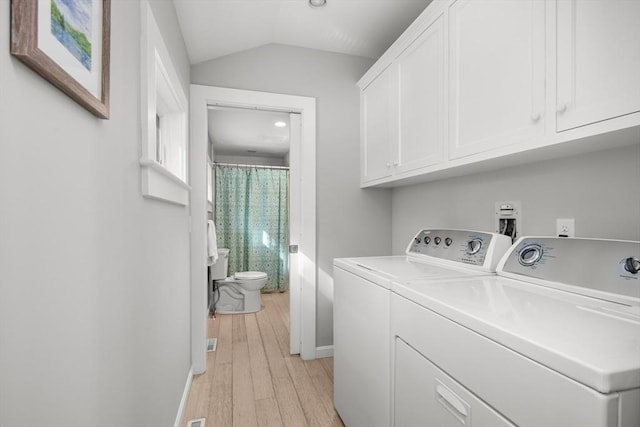 laundry room featuring cabinet space, independent washer and dryer, light wood-type flooring, baseboards, and recessed lighting