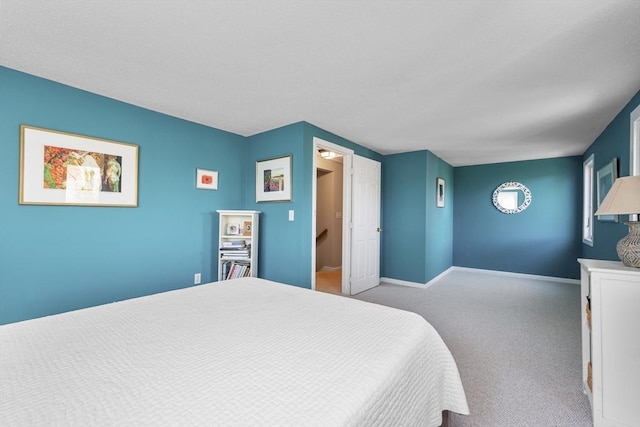 carpeted bedroom with baseboards