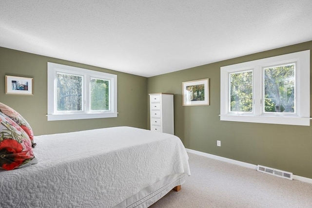 carpeted bedroom with baseboards
