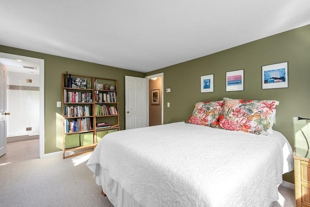 bedroom with carpet flooring, connected bathroom, and baseboards