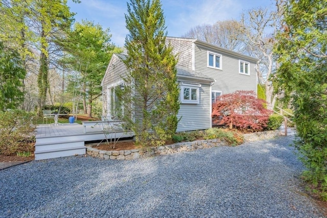 view of side of home with a wooden deck