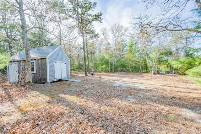 view of yard with a shed and an outbuilding