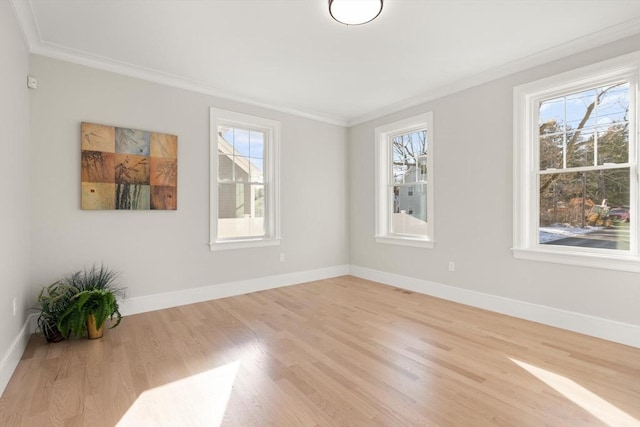 unfurnished room with ornamental molding and light hardwood / wood-style flooring