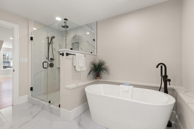 bathroom featuring shower with separate bathtub