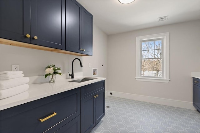 clothes washing area featuring sink, electric dryer hookup, hookup for a washing machine, and cabinets