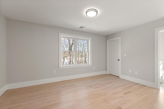 spare room with light hardwood / wood-style floors