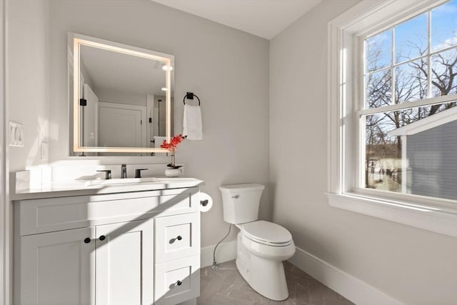 bathroom with toilet, tile patterned floors, and vanity