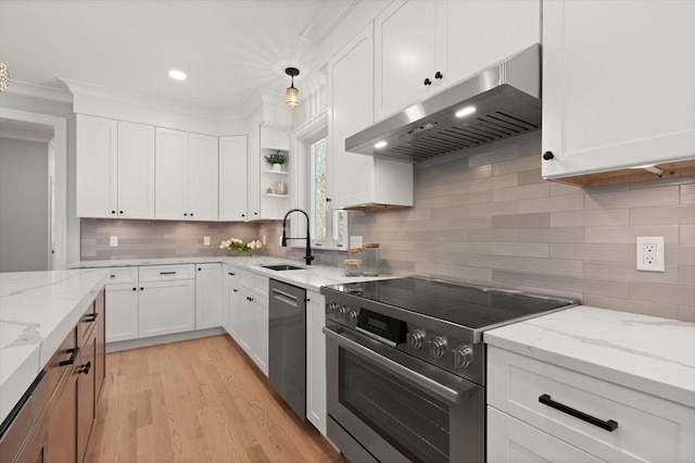 kitchen featuring range hood, hanging light fixtures, stainless steel appliances, white cabinets, and sink