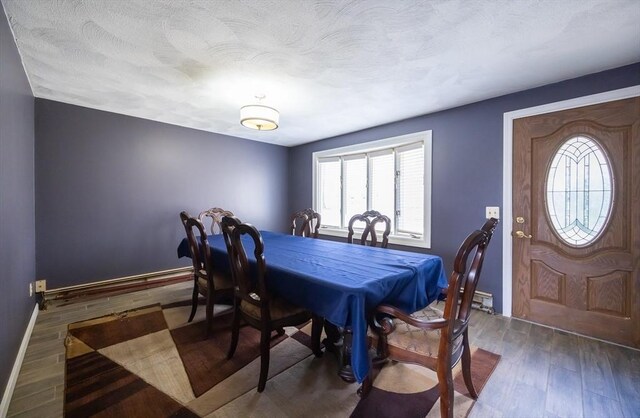 dining area with wood finished floors and baseboards