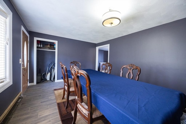 dining space featuring wood finished floors and baseboards
