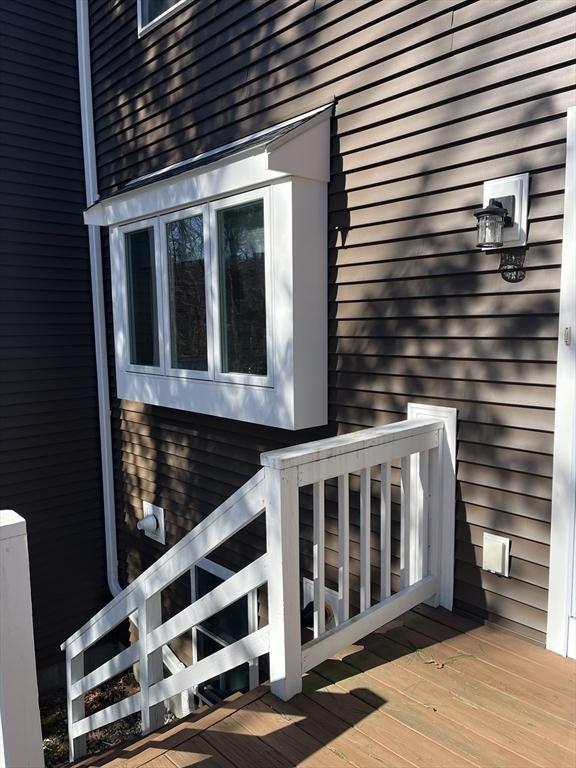 view of side of property featuring a wooden deck