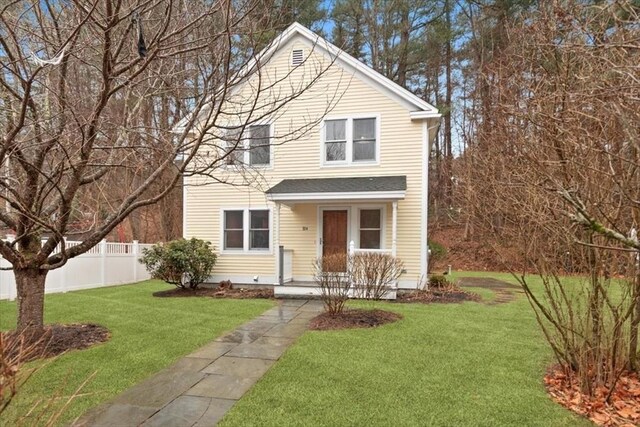 view of front of house featuring a front yard and fence