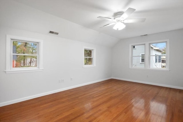 spare room with plenty of natural light, light wood finished floors, visible vents, and baseboards