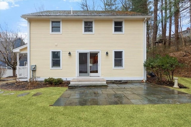 rear view of house featuring a yard and a patio area
