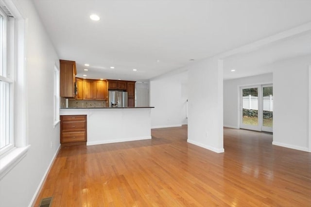 unfurnished living room with light wood finished floors, visible vents, and recessed lighting