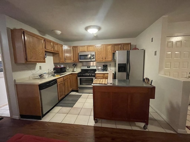 kitchen featuring appliances with stainless steel finishes and light tile patterned floors