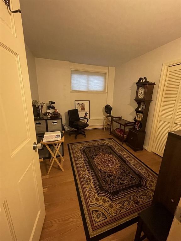 home office with hardwood / wood-style flooring