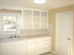 kitchen featuring white cabinets and sink