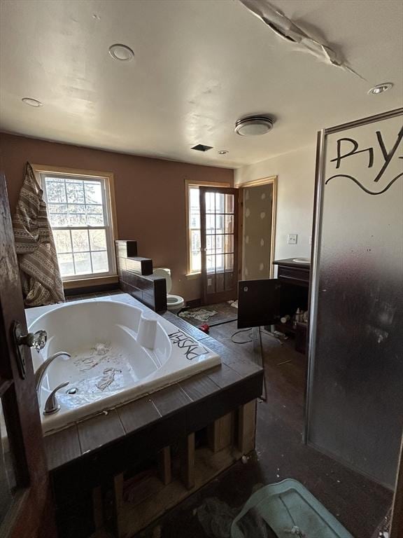 bathroom with toilet and a bath