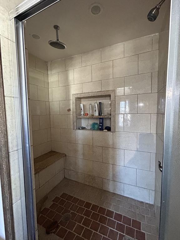 full bath featuring a tile shower