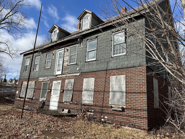 exterior space with brick siding