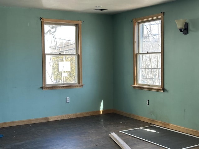 spare room featuring baseboards