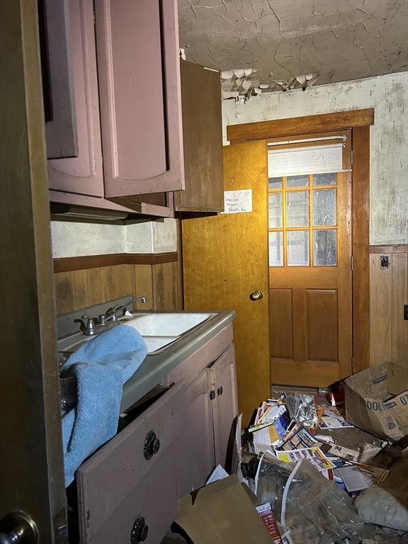 kitchen with a sink and wooden walls