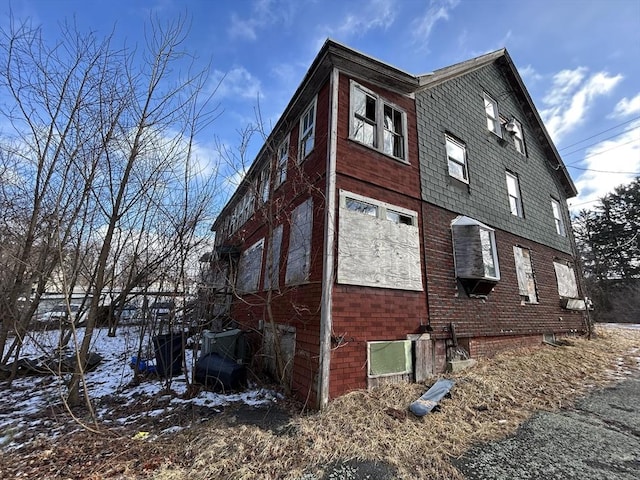 view of property exterior with brick siding