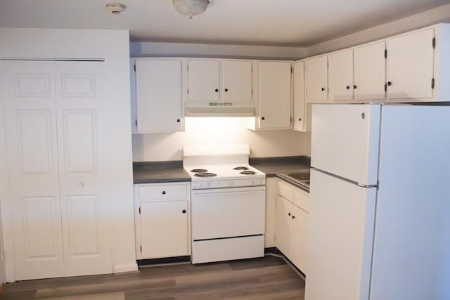 kitchen with dark countertops, white appliances, under cabinet range hood, and dark wood finished floors