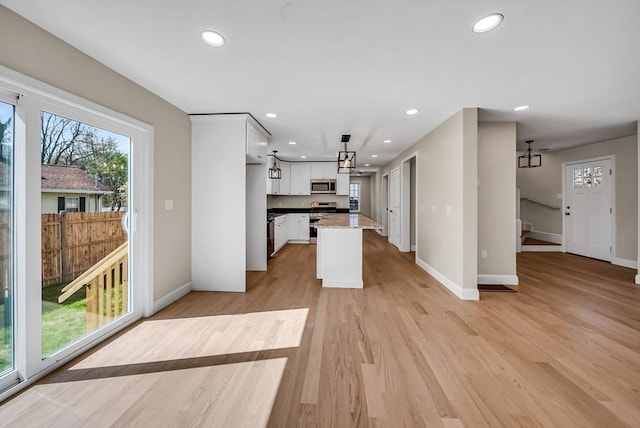 kitchen with recessed lighting, baseboards, white cabinets, and appliances with stainless steel finishes