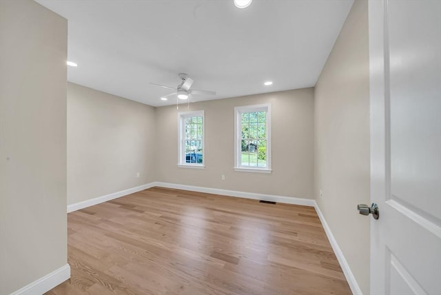 empty room featuring a ceiling fan, light wood-style flooring, baseboards, and recessed lighting