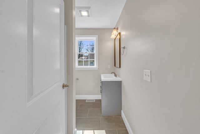 bathroom featuring baseboards, vanity, and tile patterned floors