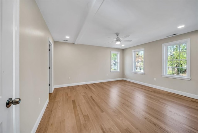 unfurnished room with light wood-type flooring, baseboards, and a ceiling fan