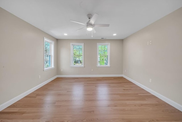 unfurnished room with plenty of natural light, a ceiling fan, light wood-style floors, baseboards, and recessed lighting