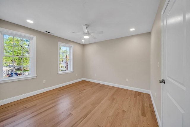 spare room featuring baseboards, light wood-style floors, a ceiling fan, and recessed lighting